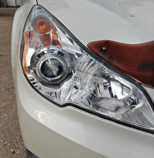 Restored headlight lens with crisp, transparent finish